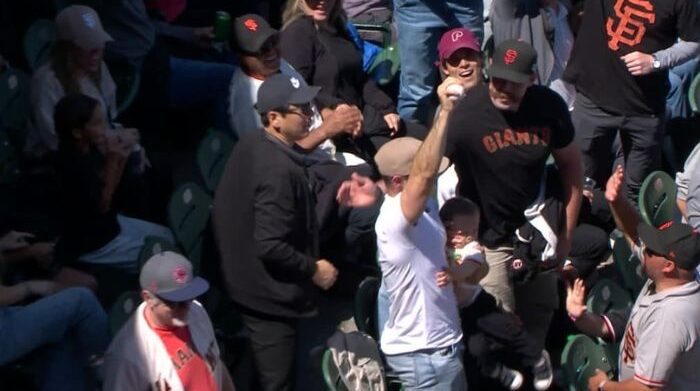 giants fan catches foul with baby in other arm